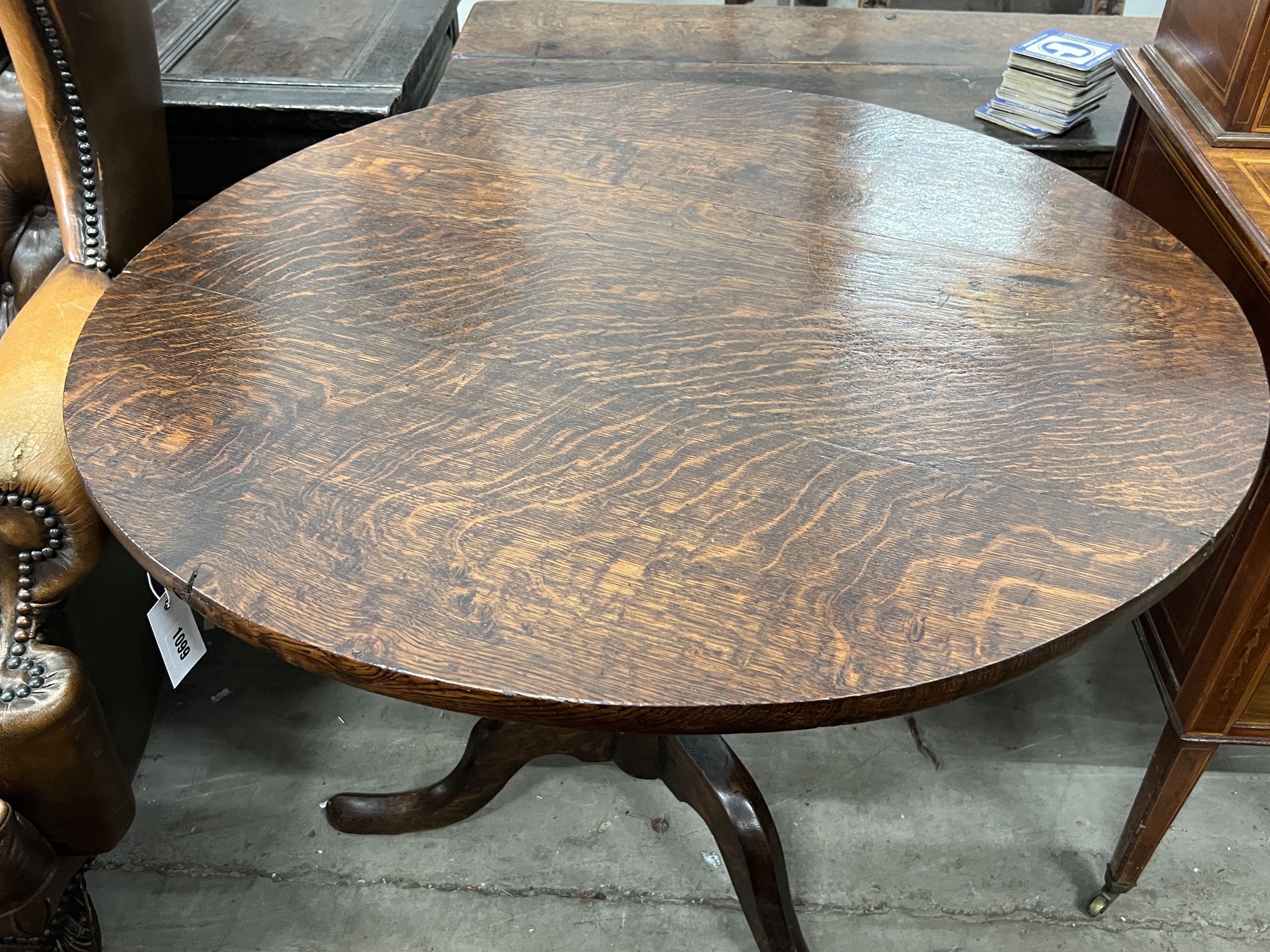 A George III circular oak tilt top tea table, diameter 87cm, height 69cm